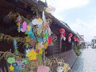 白壁の町並みに飾られた、園児たちの七夕飾りの写真です。